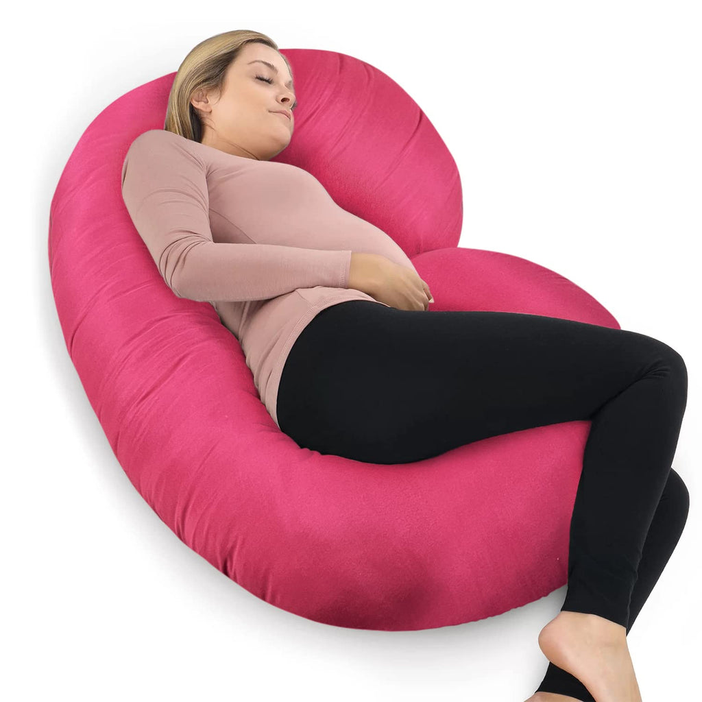 Woman lying on a pink C-shaped body pillow on a white background